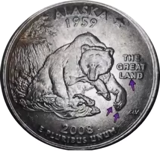 macro image of a 2008 alaska quarter with arrows noting errors on the bear's claw