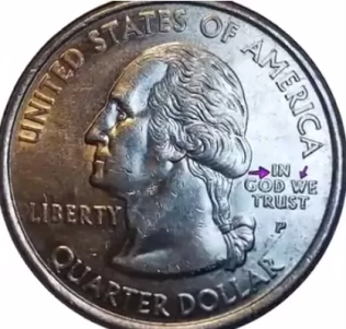 macro image of 2008 alaska quarter errors noted by arrows