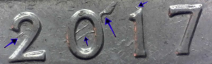 Macro photo of a vertical die gouge on a 2017-P Frederick Douglass Quarter.