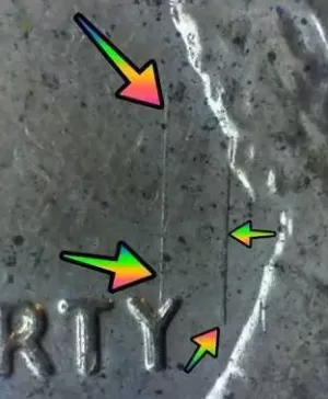 microscopic image of a Lincoln penny with arrows noting the die markings.