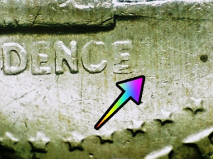microscopic image of bicentennial half dollar errors noted with arrows on a 1976 half dollar coin