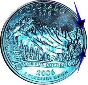 macro image of the reverse of a 2006 colorado quarter displaying a cud error