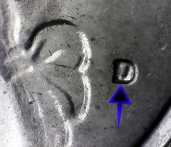Macro image of a rare filled-in D mint mark on the obverse of a 1776-1976 Bicentennial Drummer Boy Quarter.