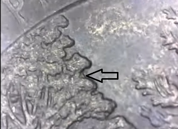 Pictured Rocks Black Beauty Michigan 2018 Quarter doubled die reverse with arrow noting doubling of coin