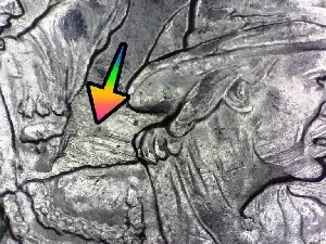 microscopic image of an arrow noting a feeder finger error on a George Rogers Clark quarter