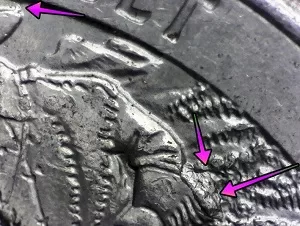microscopic image of arrows noting an error on the reverse of a 2016 North Dakota Quarter