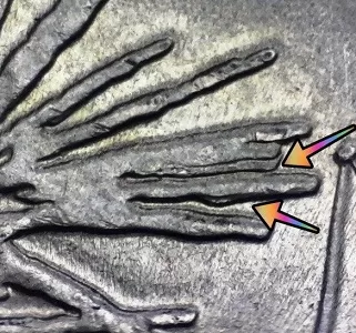 up close image of a 2013 Fort McHenry Maryland Quarter with arrows noting the doubling of the firework explosion